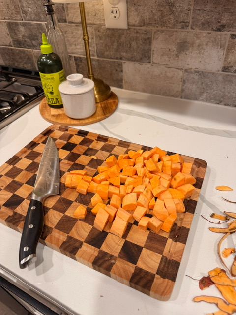 chopped sweet potatoes on cutting board