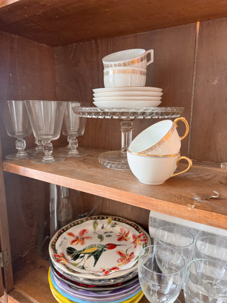 decorative glasses, teacups, cake stand, colorful plates
