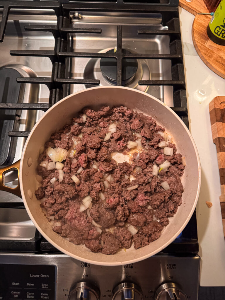 browning meat and onions for healthy egg roll bowl
