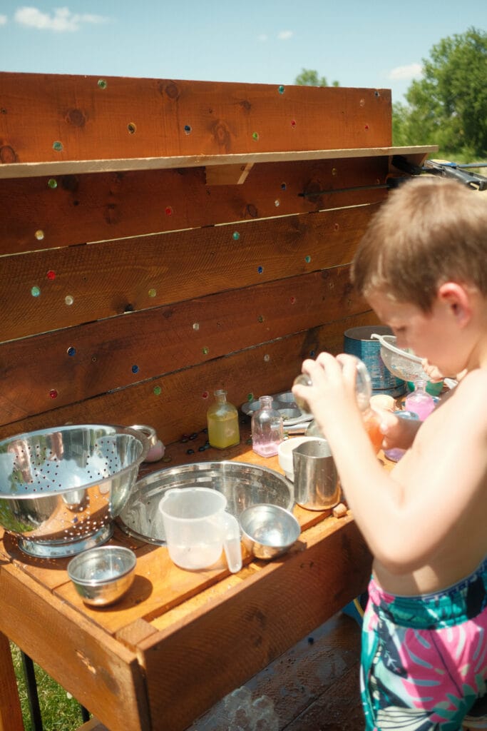 kids playing at DIY mud kitchen