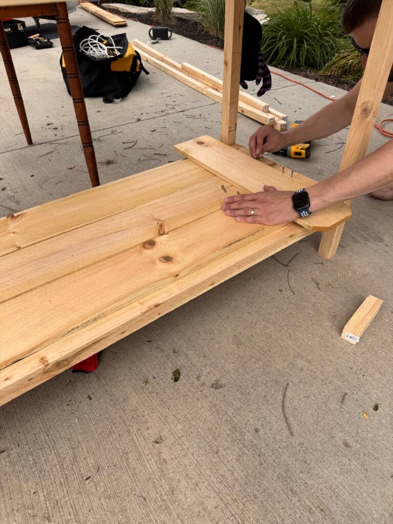 attaching wood panels to DIY Mud Kitchen